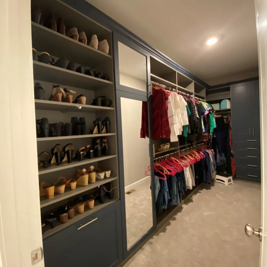 a closet with clothes and shoes