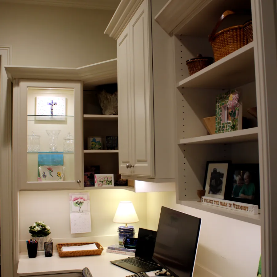 a desk with a laptop and a lamp