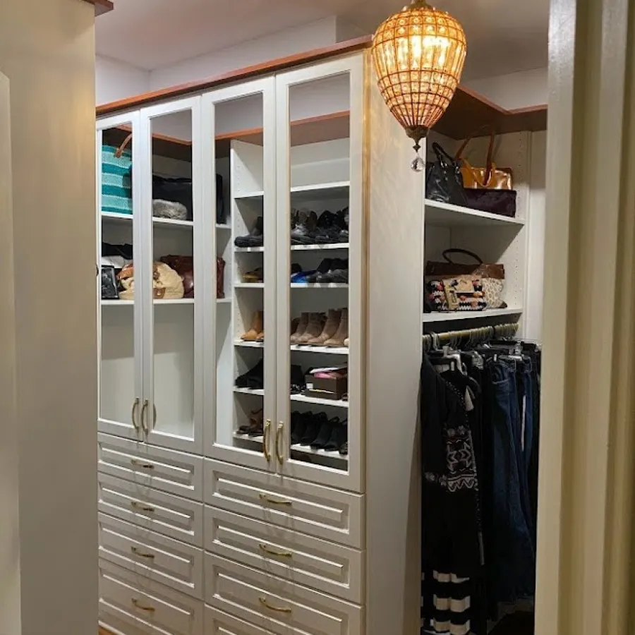 a closet with a mirror and a light from the ceiling