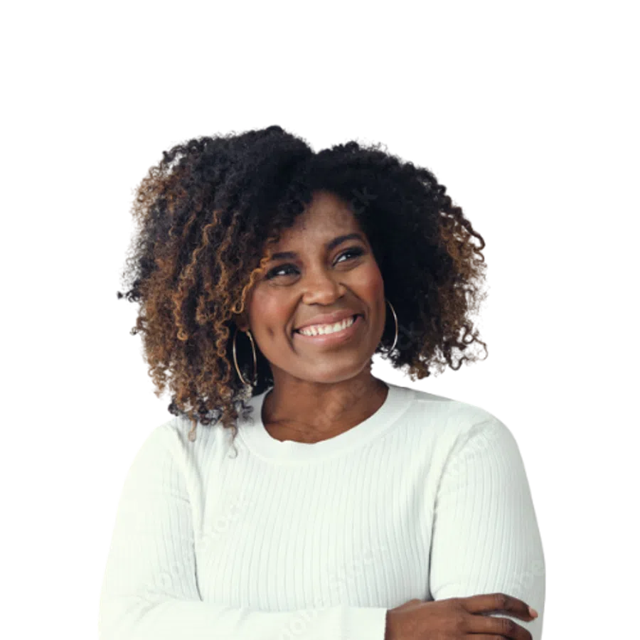 Smiling woman with natural curly hair wearing a white sweater and hoop earrings with arms crossed.