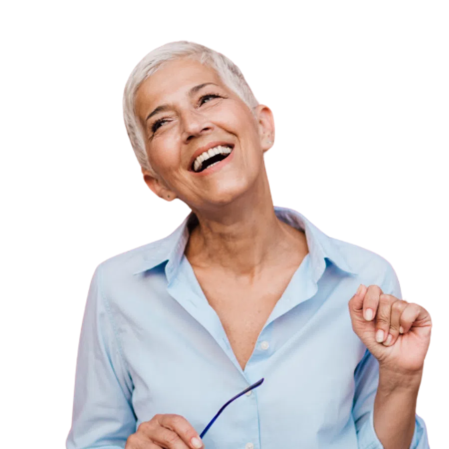 Smiling senior woman with short white hair holding glasses wearing a light blue shirt isolated on white