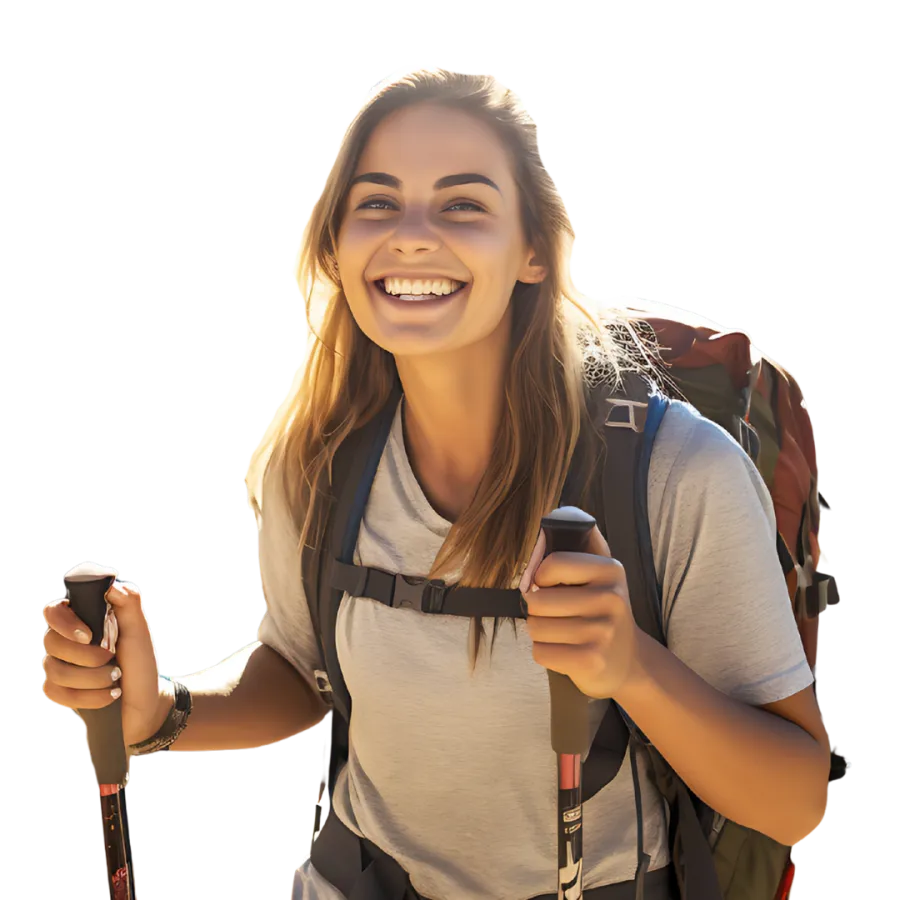 Smiling young woman hiking with backpack and trekking poles enjoying outdoor adventure.