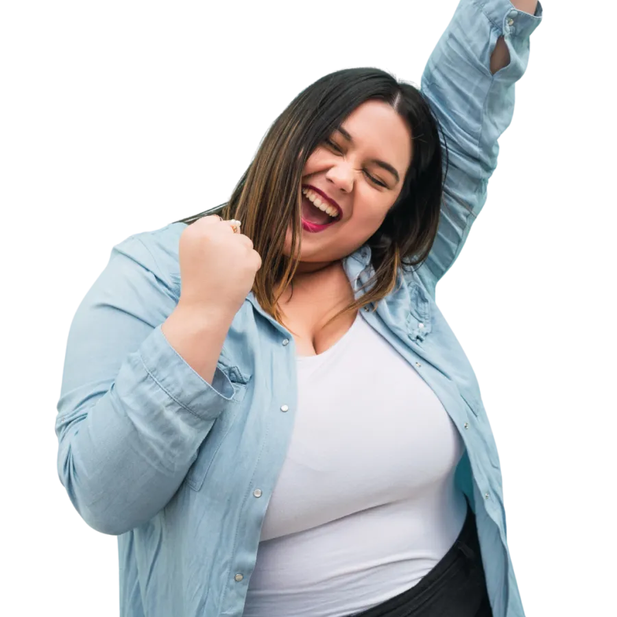 Happy plus-size woman in blue shirt and white top celebrating with raised fist and closed eyes