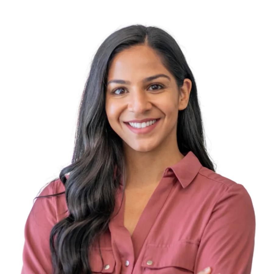 Confident woman with long dark hair wearing a mauve button-up shirt smiling with arms crossed.