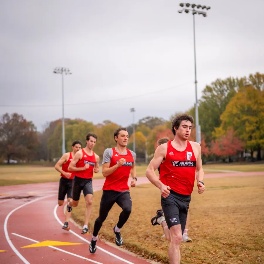 a group of people running on a track