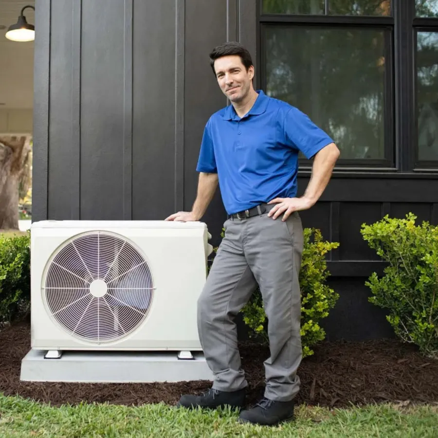 a man standing next to a fan