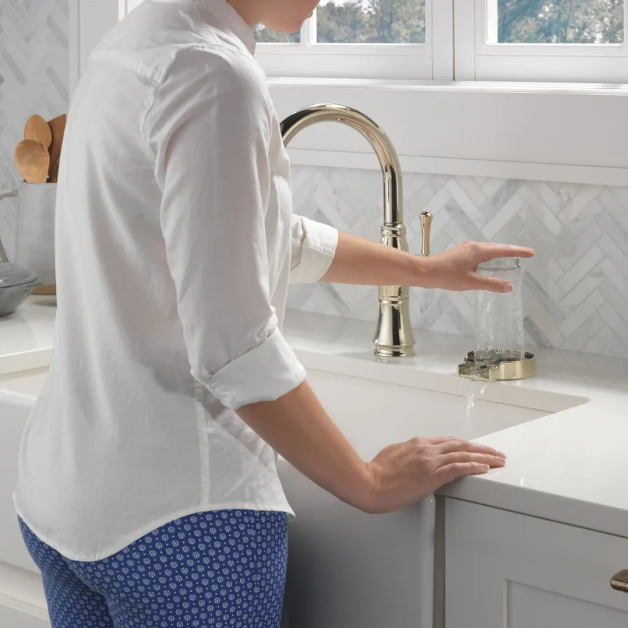 a person washing the hands in the sink