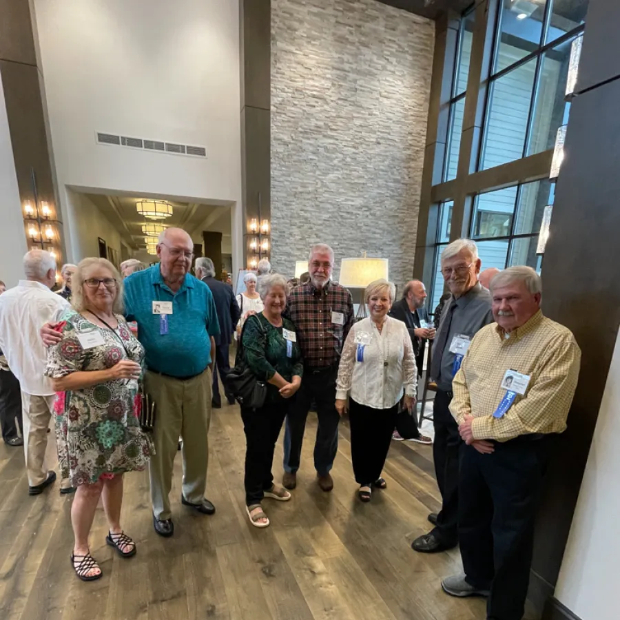 a group of people standing in a hallway