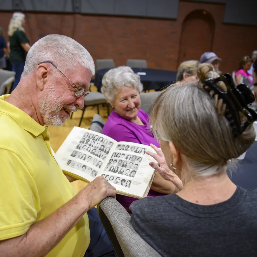 a man and a woman holding a paper