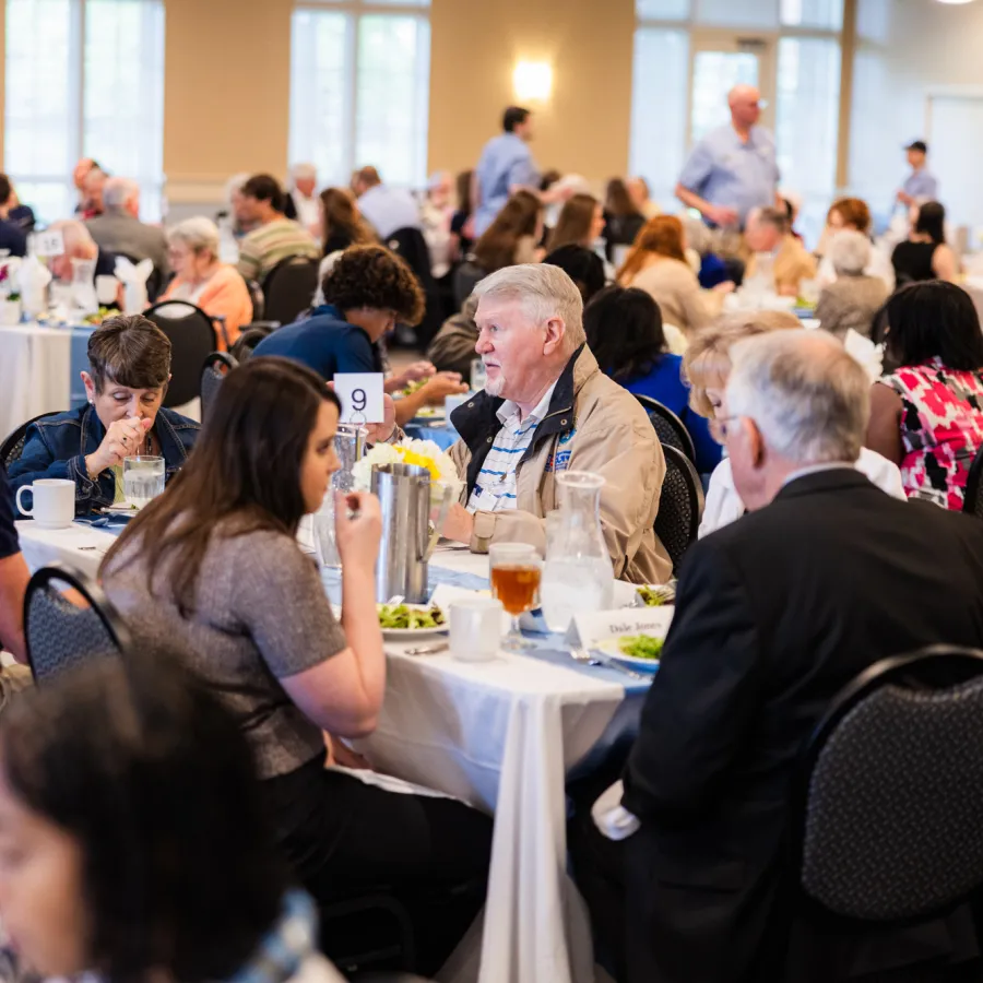 a group of people sitting at tables