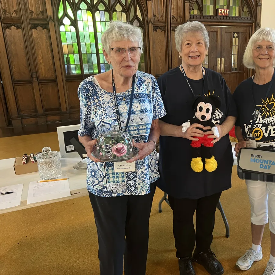 a group of women holding a stuffed animal