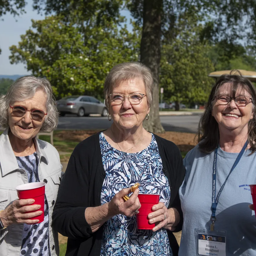 a group of women holding red cups