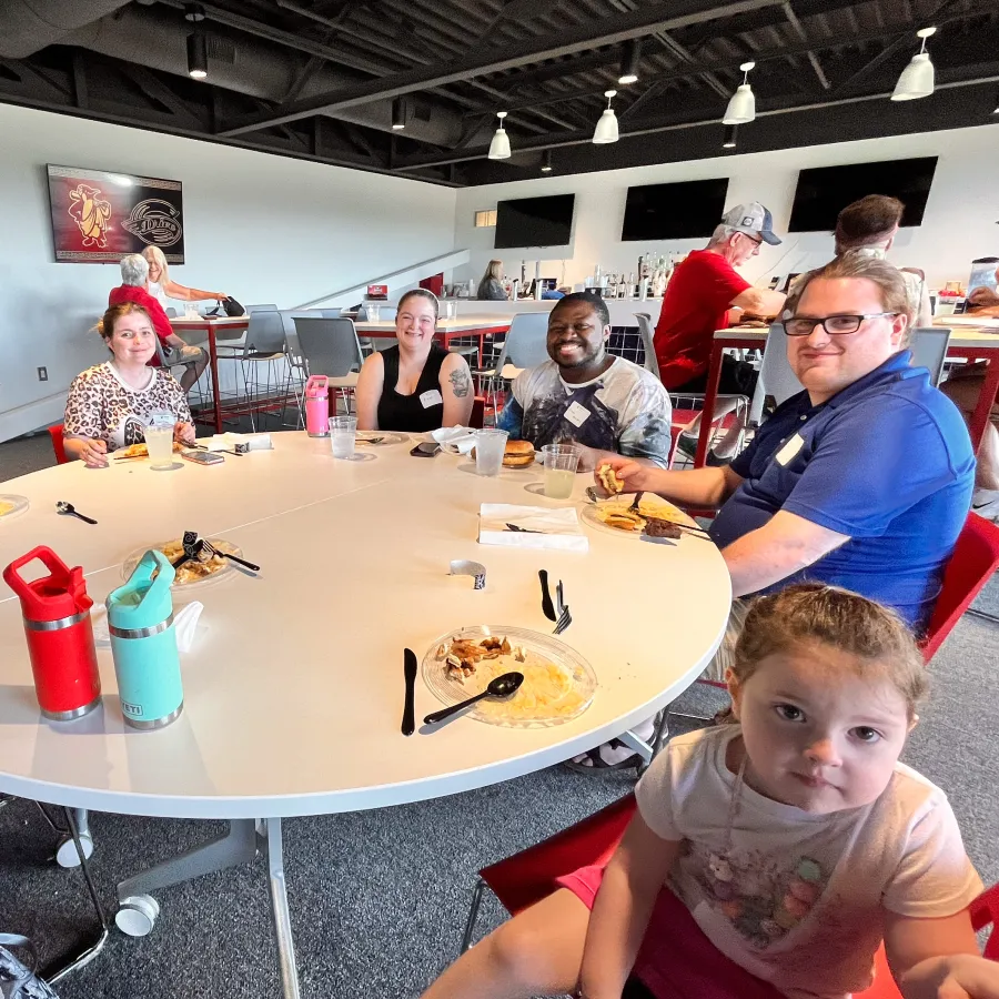 a group of people sitting around a table