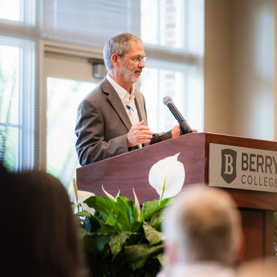 a person speaking at a podium