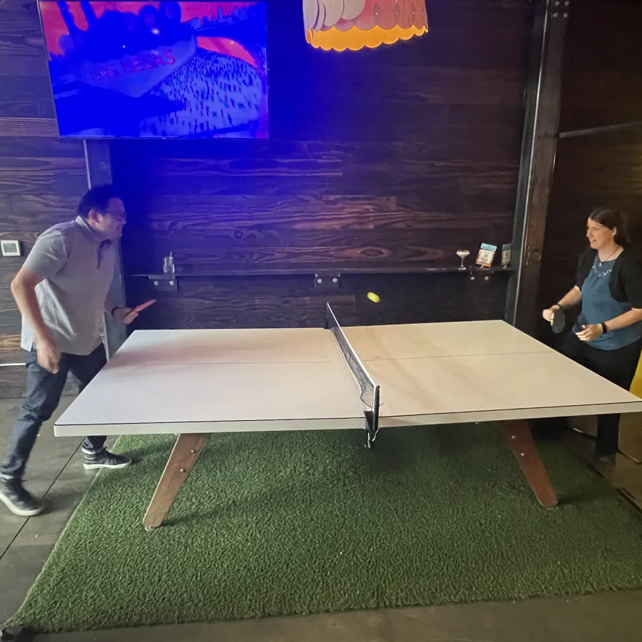 a man and a woman playing pool