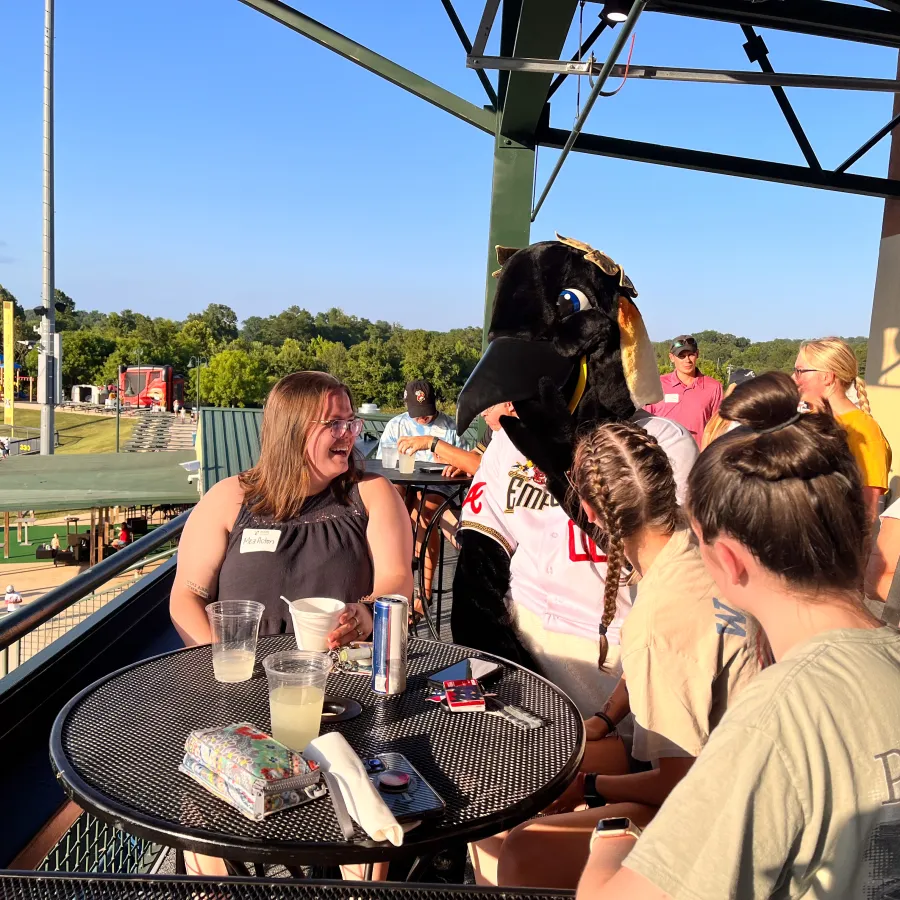 a dog sitting on a table with a person in a horse mask