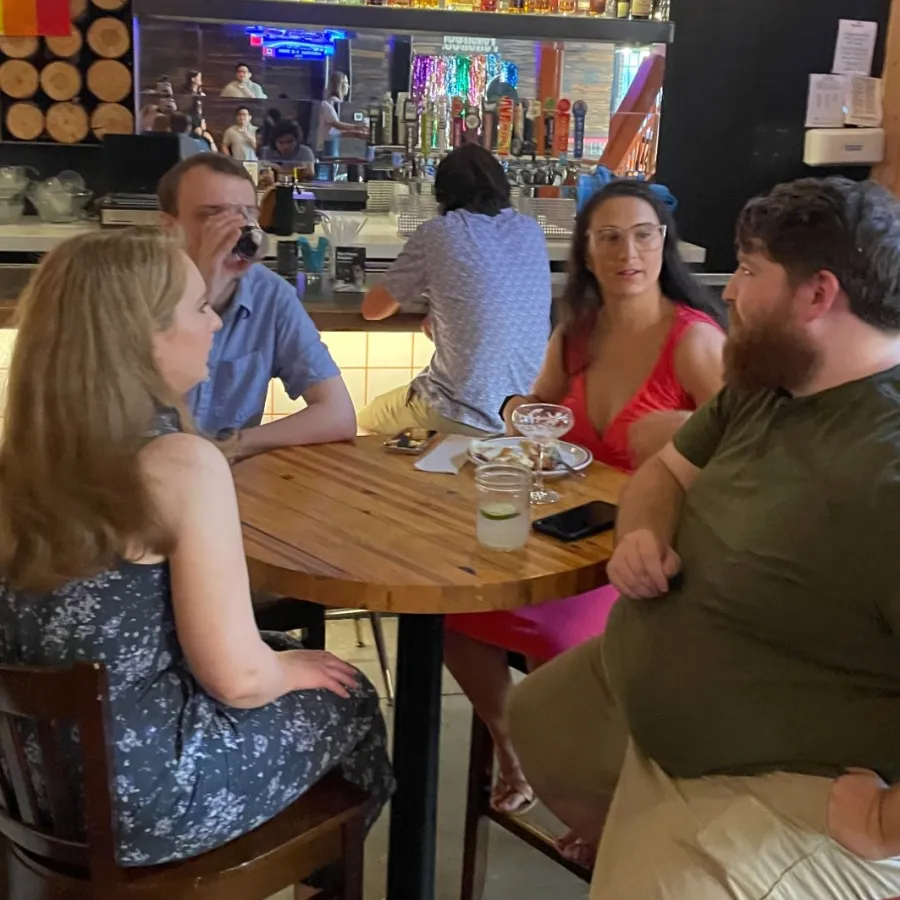 a man and a woman sitting in a chair in a bar