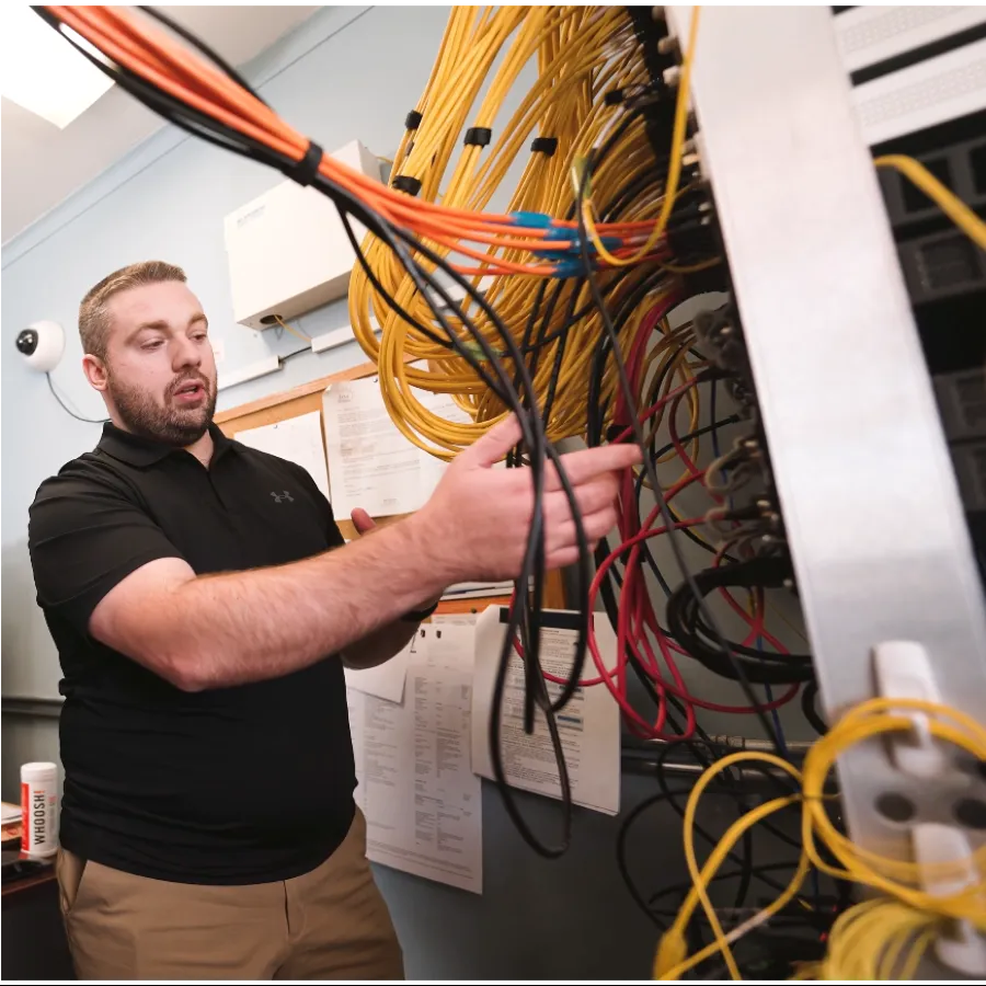 a man holding a yellow and black wire