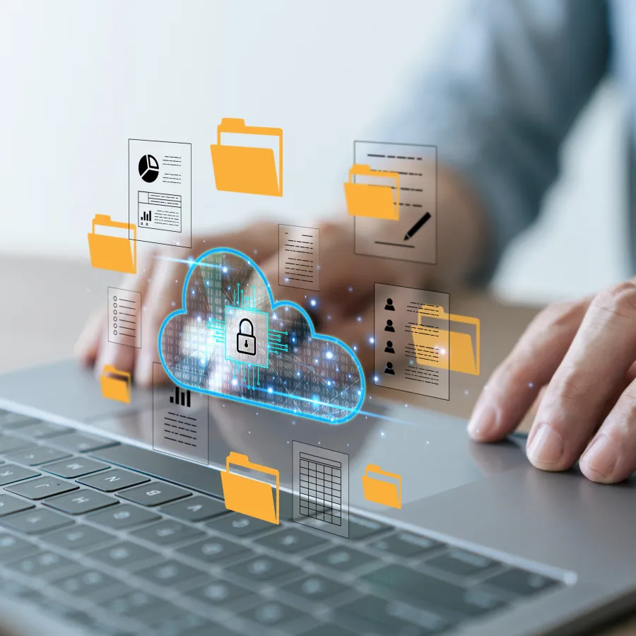 Hands typing on laptop with secure cloud storage and digital folders icons floating above keyboard.