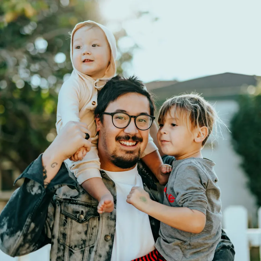 a person holding a couple of children