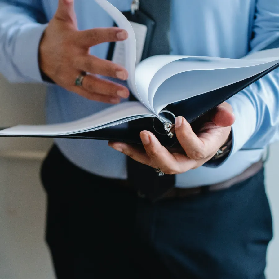 A business person holding an open Binder
