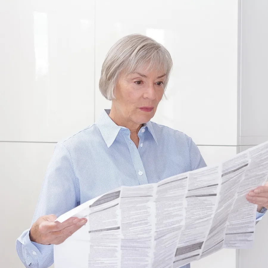 A woman reading a large Instruction Sheet