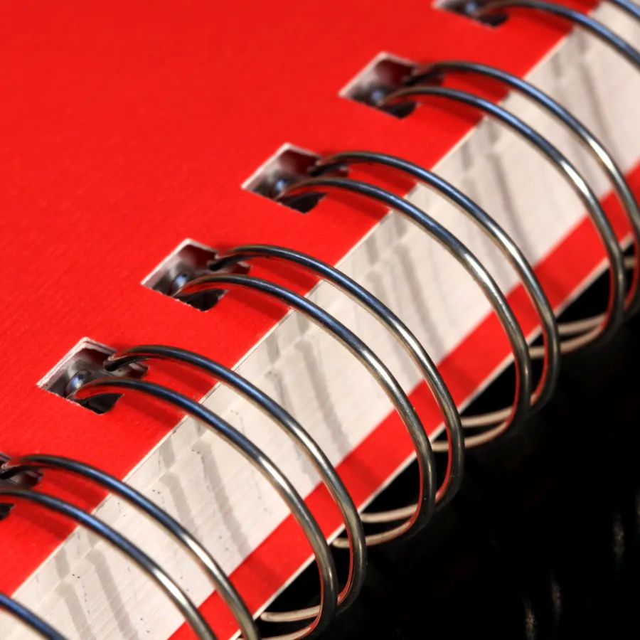 A red book with silver Wire-O Binding