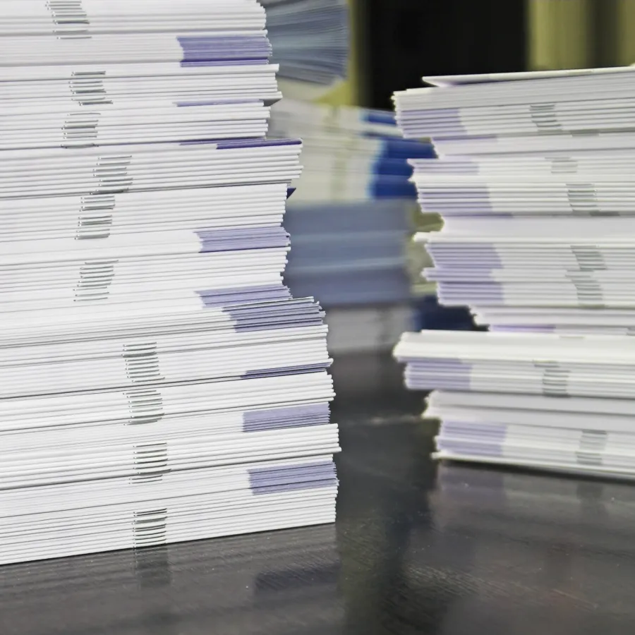Stacks of Printed Newsletters sitting on a work table