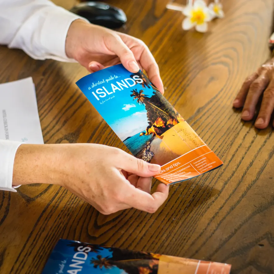A man holding a colorful Brochure