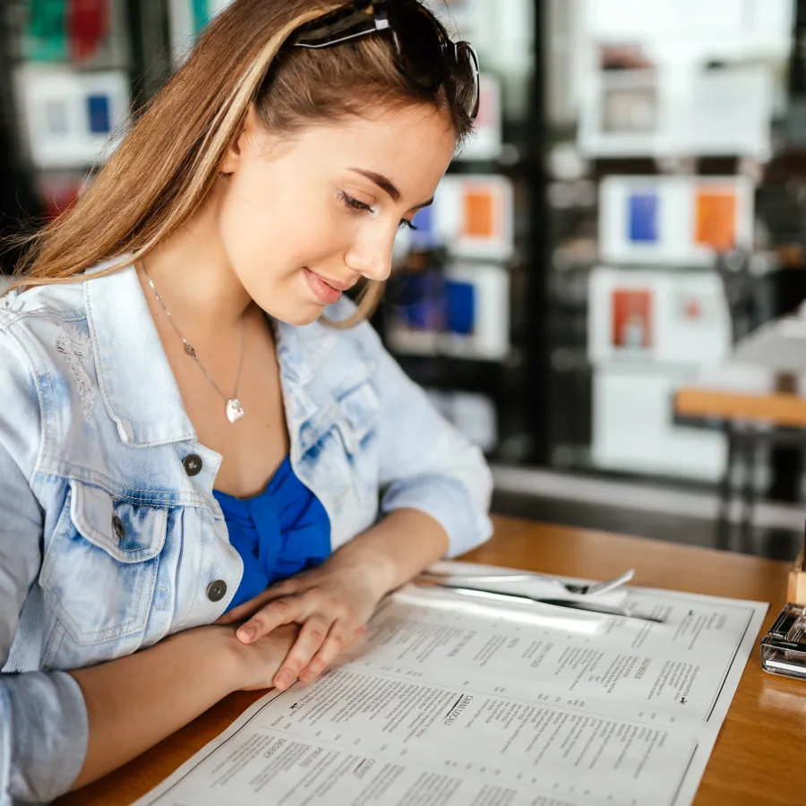 a woman looking at a placemat