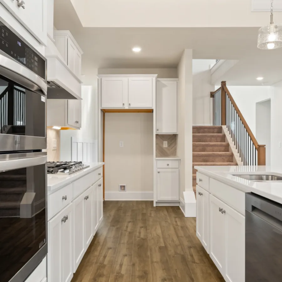 a kitchen with white cabinets