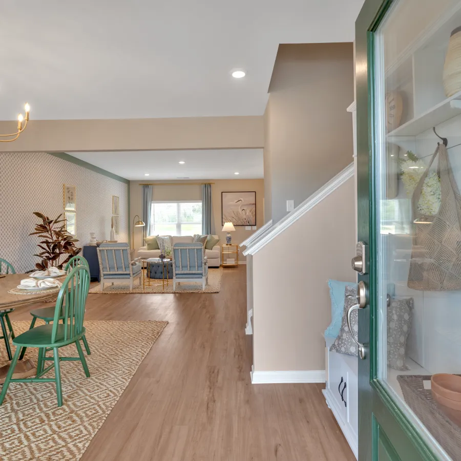 Welcoming interior view of a modern dining area with green chairs and stylish decor elements.