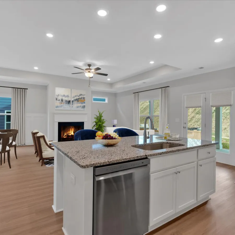Modern open-plan kitchen with granite island, stainless steel appliances, wood flooring, and cozy fireplace in the dining area.