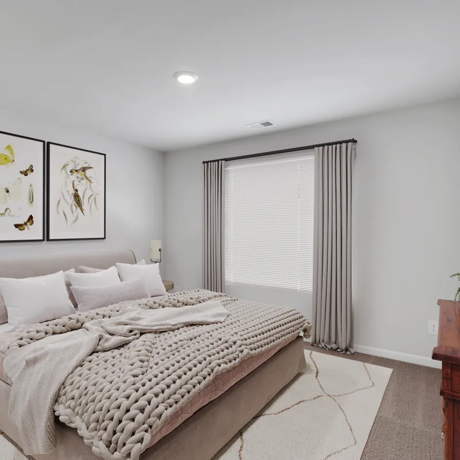 Cozy bedroom featuring neutral tones, large bed, art on walls, and natural light.