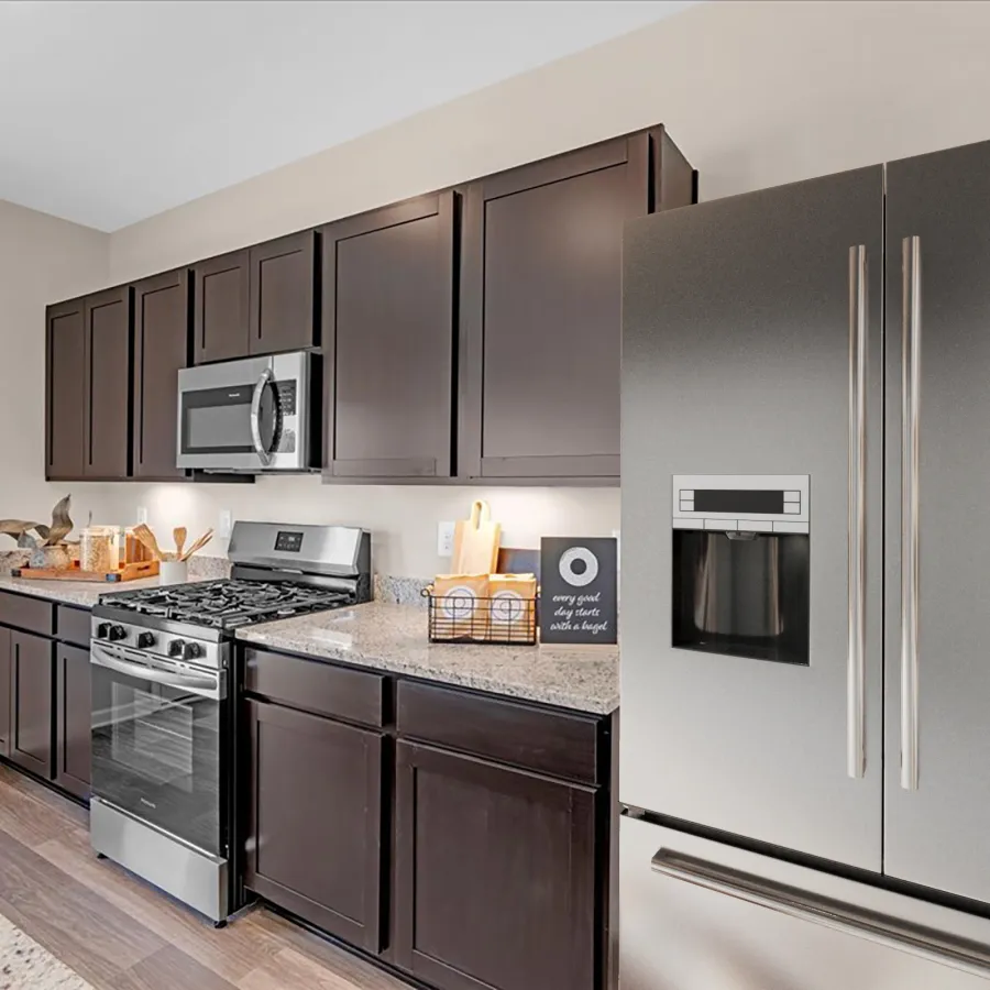 Modern kitchen with stainless steel appliances and dark wood cabinets, featuring a granite countertop.