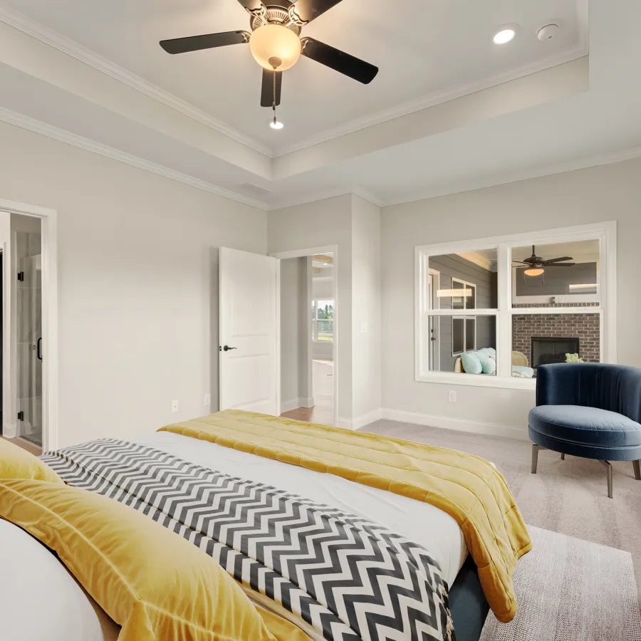 a bedroom with a bed and a fan