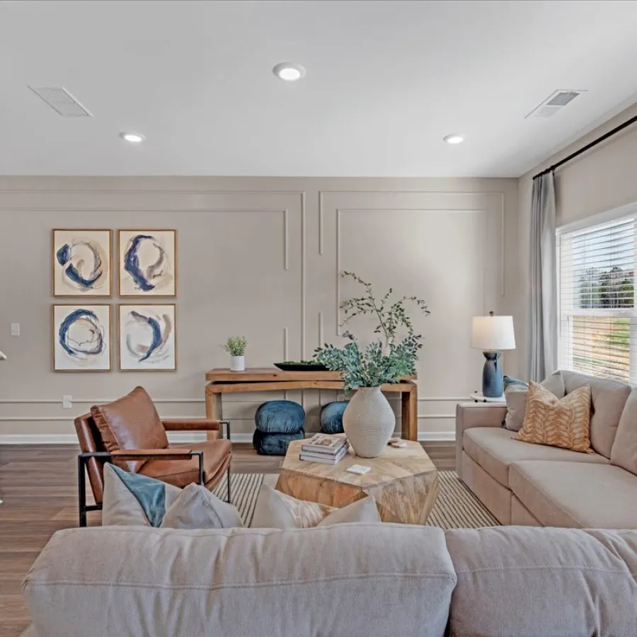 Modern living room featuring comfortable seating, artwork, and natural light.