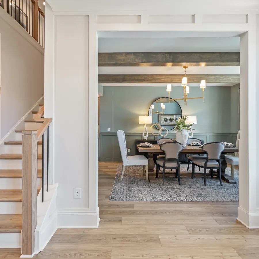 a dining room with a staircase