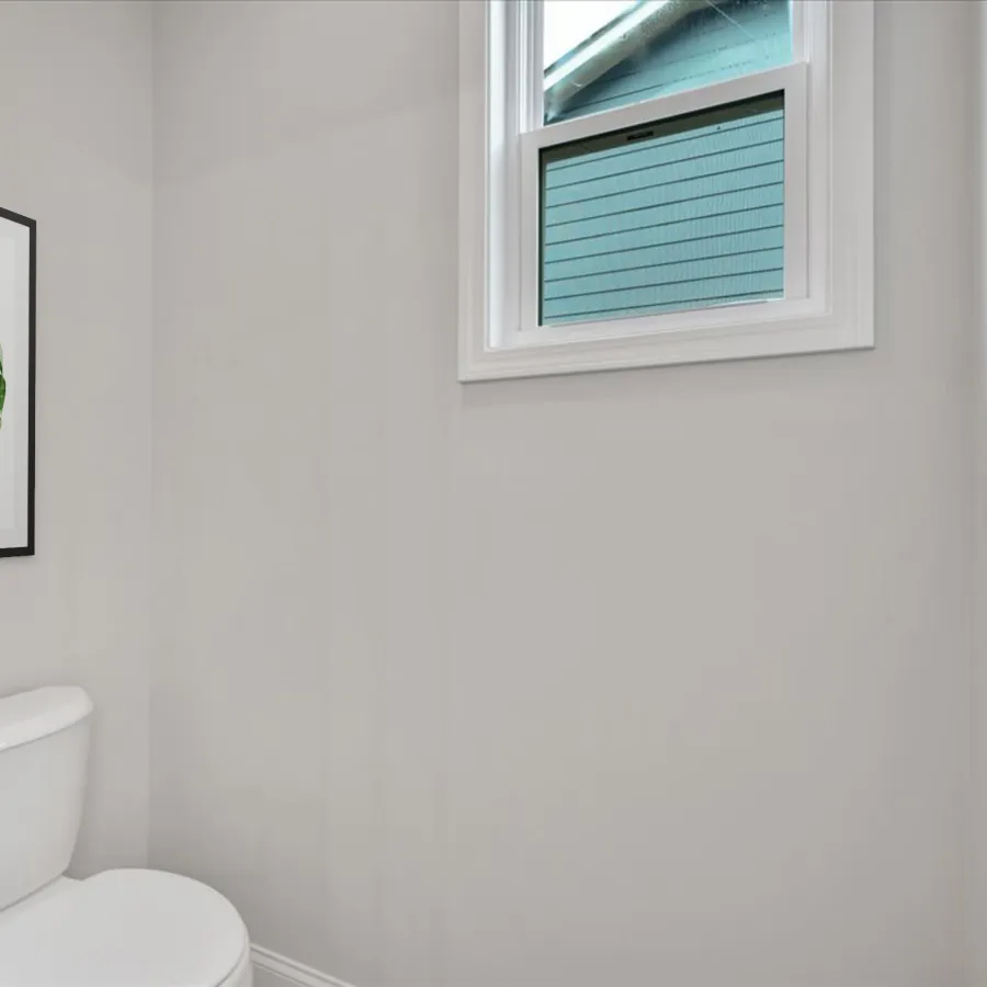 Minimalist bathroom with white toilet, gray walls, a window, and framed green leaf artwork.
