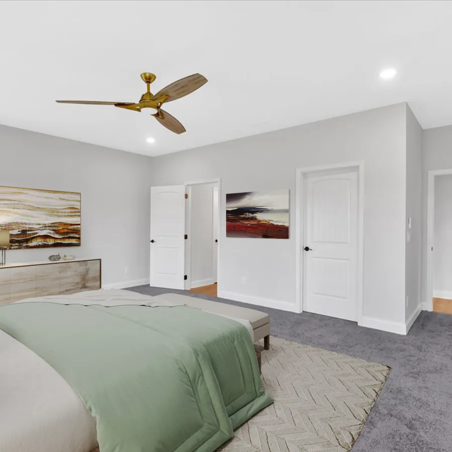 Spacious modern bedroom with green bedding, wooden ceiling fan, abstract wall art, and neutral gray carpet flooring