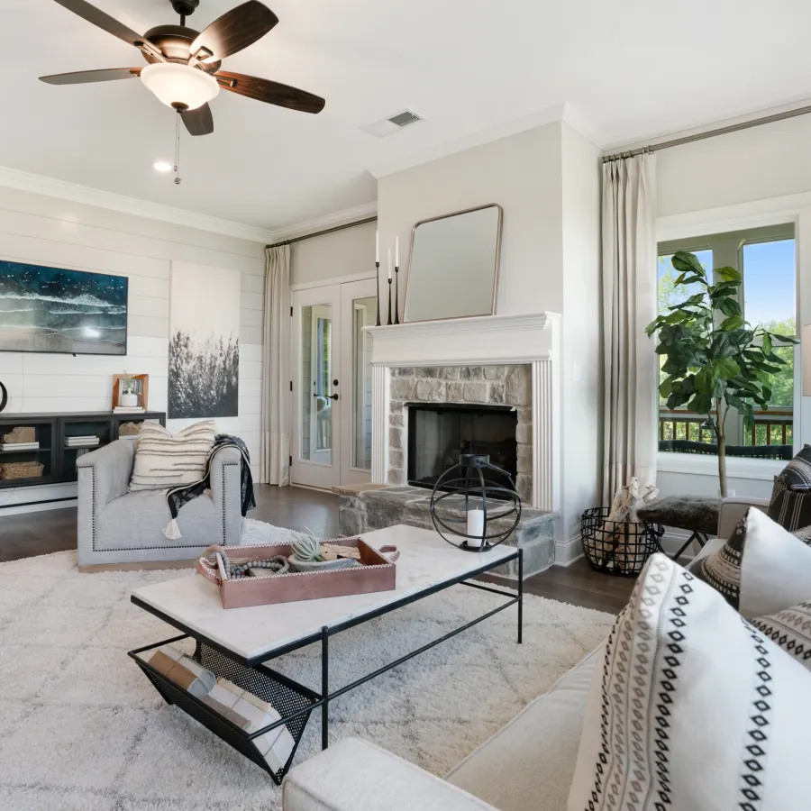 a living room filled with furniture and a large window
