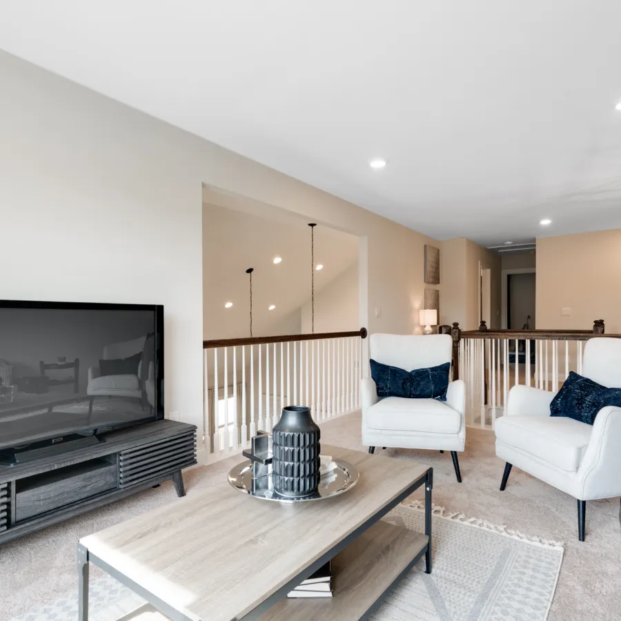 a living room filled with furniture and a flat screen tv