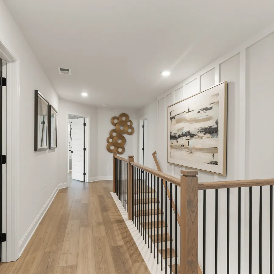 a hallway with a wood railing