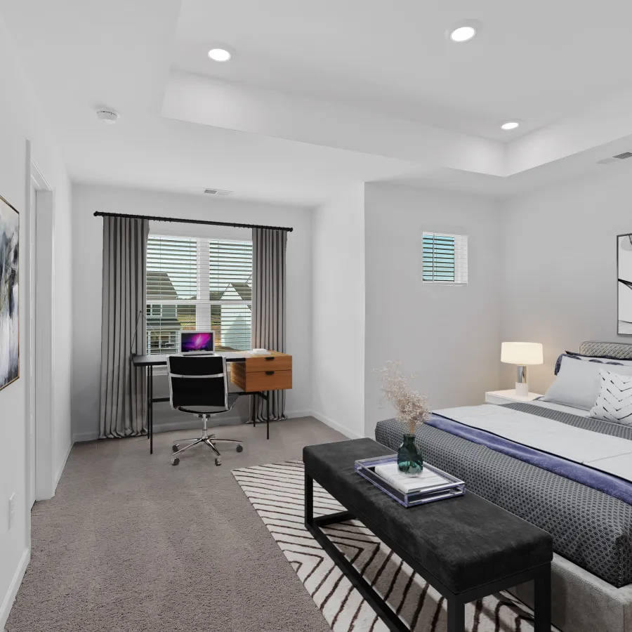 Modern bedroom with a bed, desk, and contemporary decor in neutral colors.