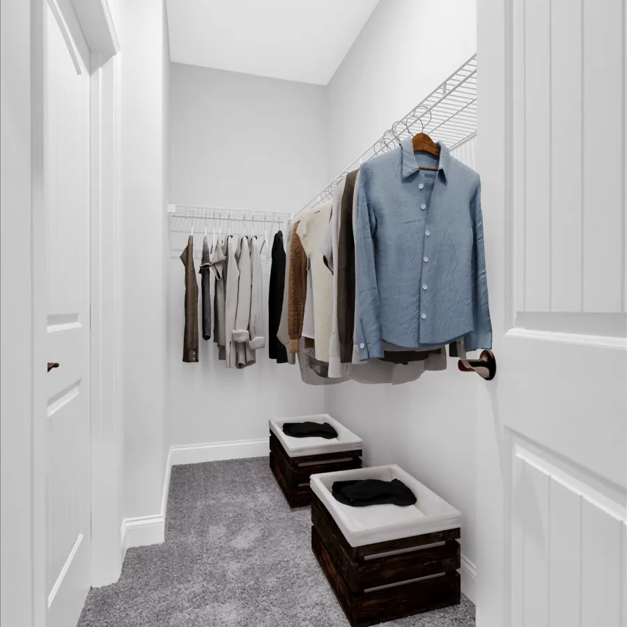 Small walk-in closet with gray carpet, white walls, hanging clothes on wire racks, and two cushioned wooden crates.