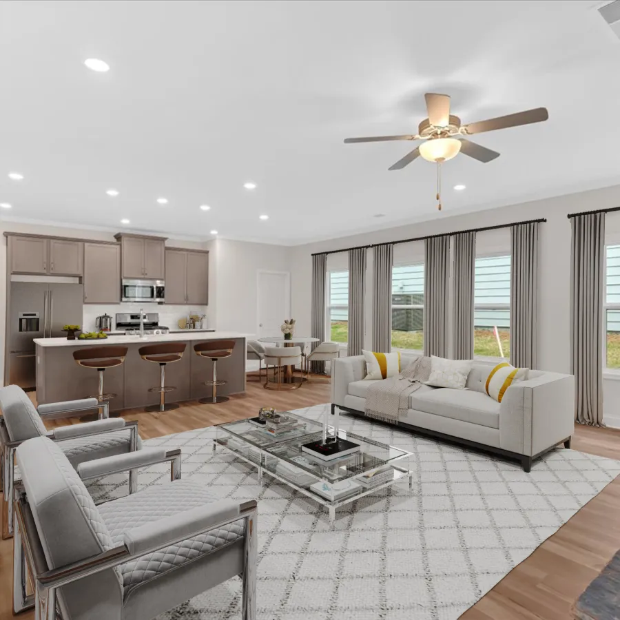 Modern living room with stylish furniture, large windows, and open kitchen layout for a bright ambiance.