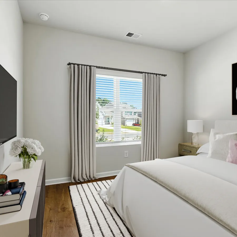 Modern bedroom with white bed, soft pillows, wood flooring, large window with curtains, and a wall-mounted TV.