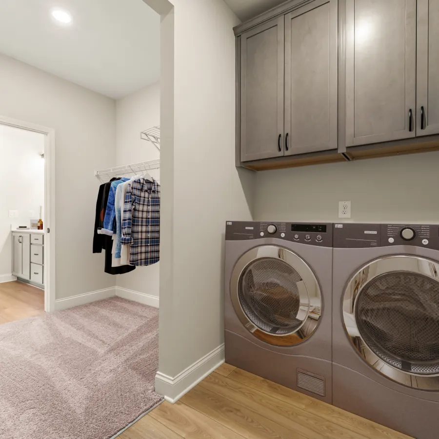 a room with a washing machine and a rug