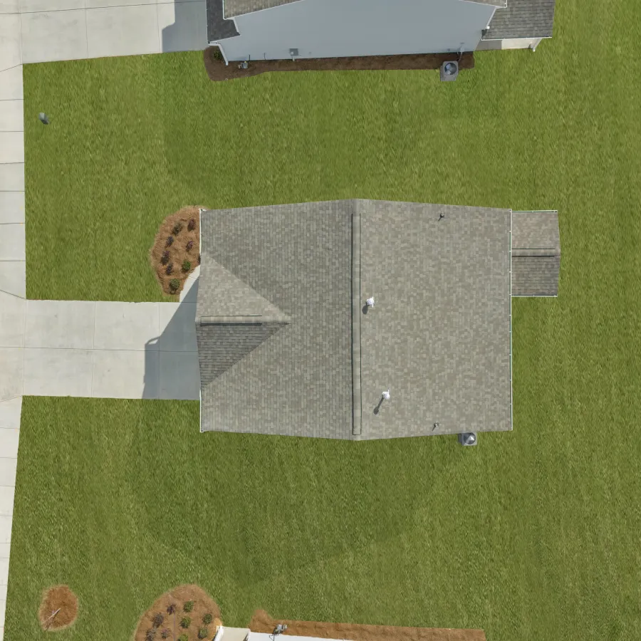 Aerial view of a modern house with a gray roof, concrete driveway, and well-maintained green lawn beside a curved road.