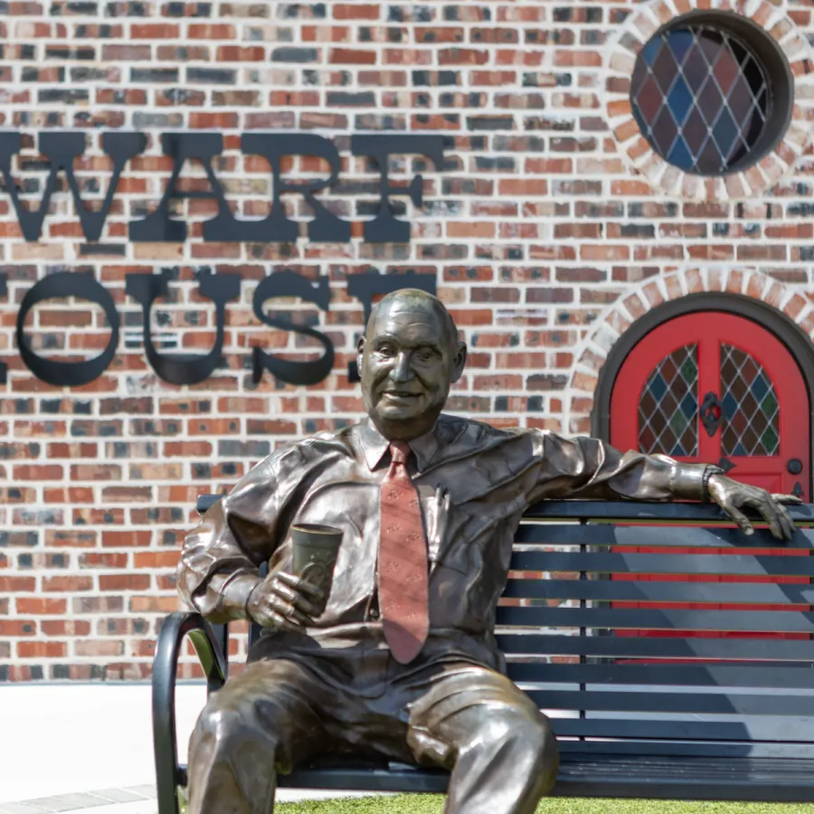 a statue of a man sitting on a bench